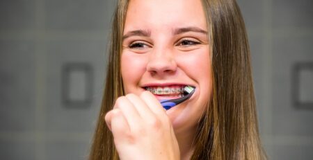 Teen brushing her teeth