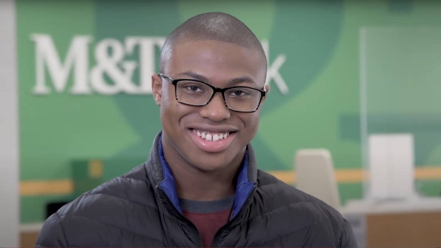Young man smiling at M&T Bank.